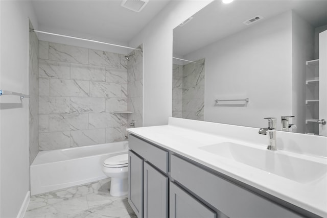 full bathroom featuring vanity, tiled shower / bath combo, and toilet