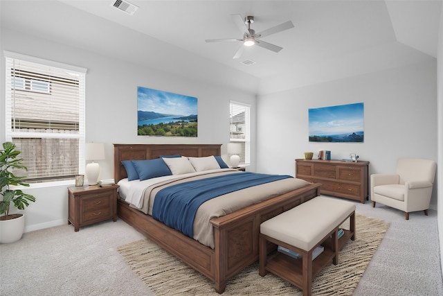 carpeted bedroom with ceiling fan and vaulted ceiling