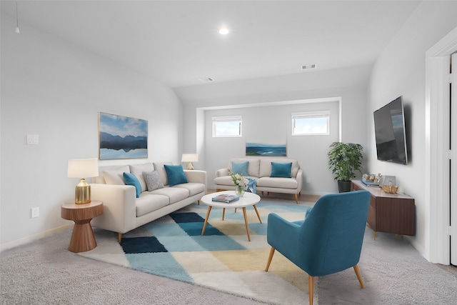 carpeted living room with vaulted ceiling