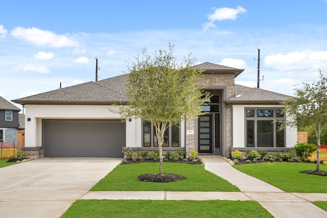 view of front of property with a front lawn and a garage