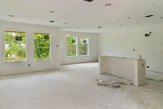 unfurnished room featuring plenty of natural light