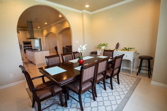 tiled dining area featuring crown molding