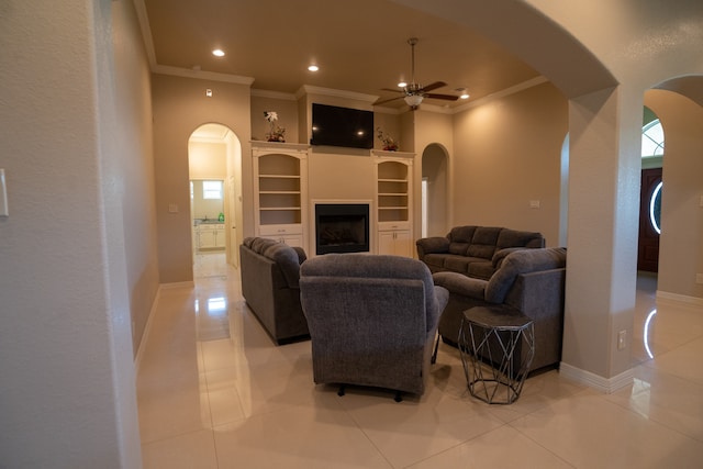 living room with ornamental molding, plenty of natural light, ceiling fan, and light tile floors