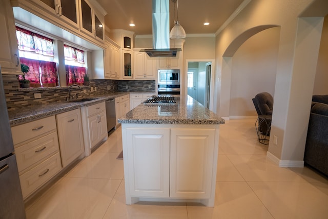 kitchen featuring decorative light fixtures, a kitchen island, appliances with stainless steel finishes, tasteful backsplash, and island exhaust hood