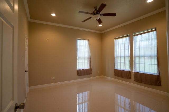 unfurnished room with ornamental molding, ceiling fan, and light tile floors