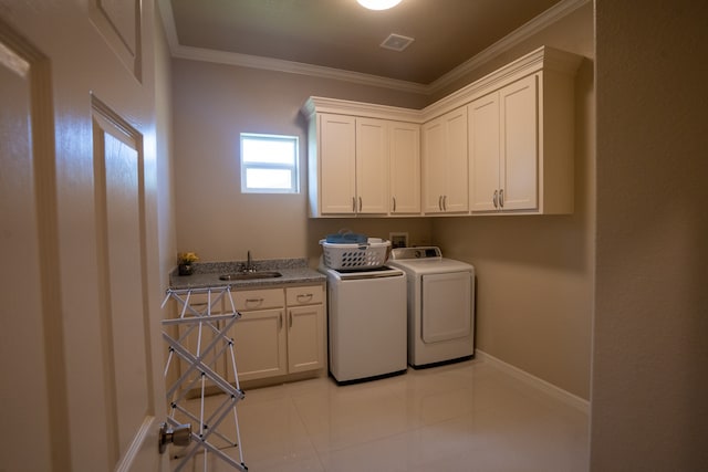 washroom with washer and clothes dryer, crown molding, light tile floors, sink, and cabinets