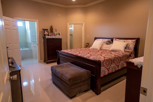 bedroom with ensuite bathroom, light tile flooring, and crown molding