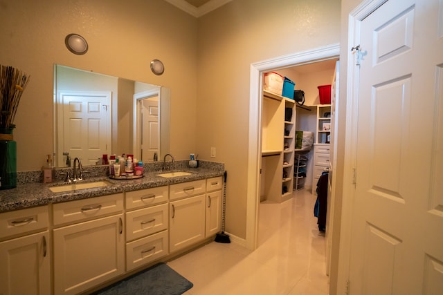 bathroom with tile floors and dual bowl vanity