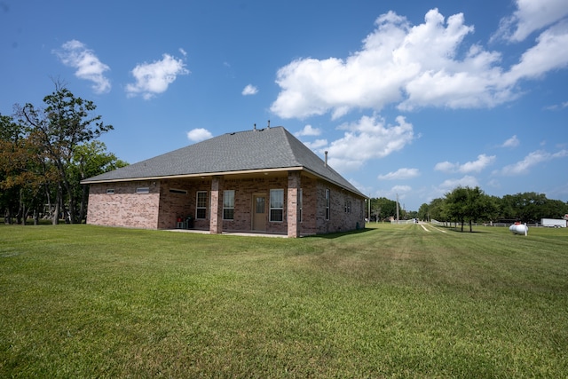 rear view of house featuring a yard