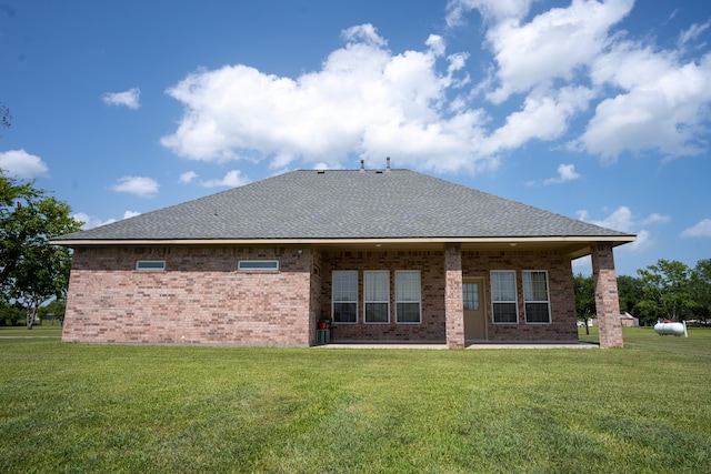 rear view of house with a lawn