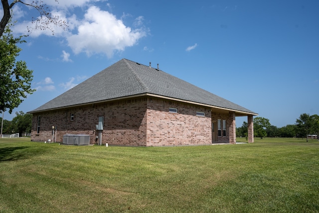 view of home's exterior featuring central AC unit and a lawn