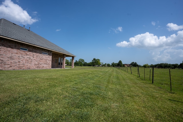 view of yard with a rural view