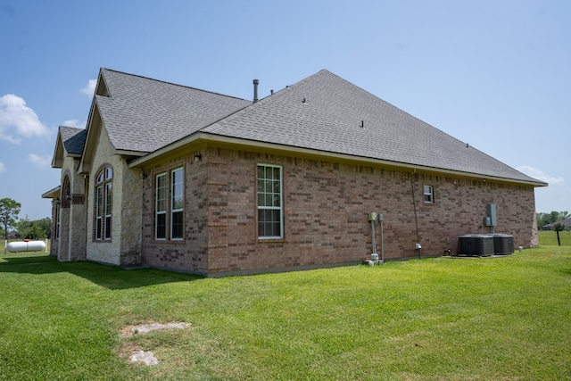 view of home's exterior featuring a yard and central AC