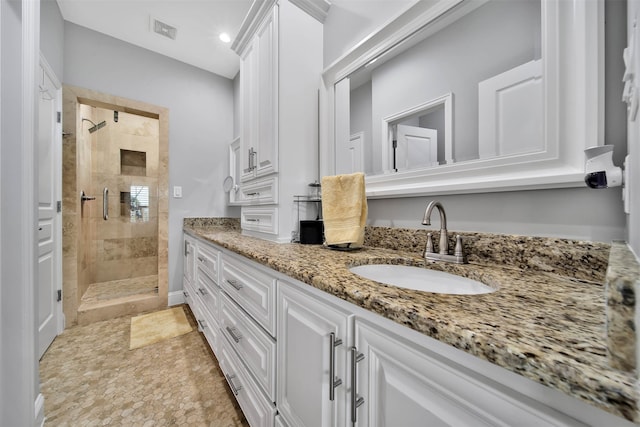 bathroom featuring walk in shower, vanity, and tile flooring