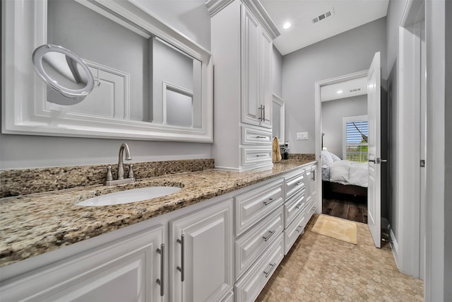 bathroom with tile flooring and large vanity