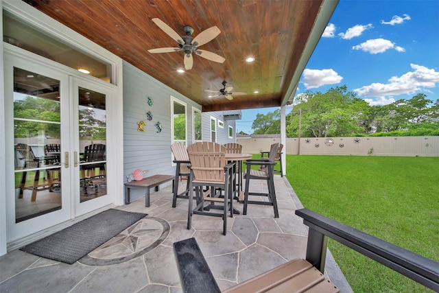 view of terrace featuring french doors and ceiling fan