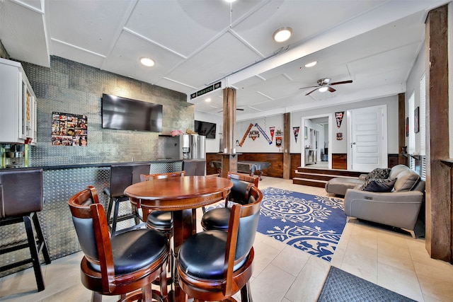 dining room with ceiling fan and light tile flooring