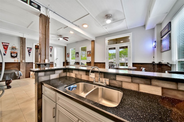 kitchen featuring light tile flooring, french doors, sink, dark stone countertops, and ceiling fan