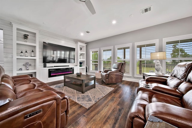 living room with dark hardwood / wood-style flooring and built in features