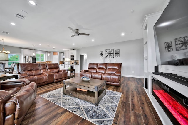 living room with ceiling fan and dark hardwood / wood-style floors