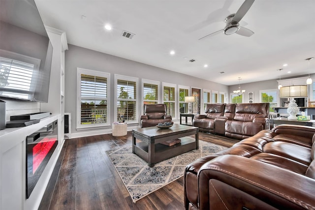 living room featuring ceiling fan and dark hardwood / wood-style floors