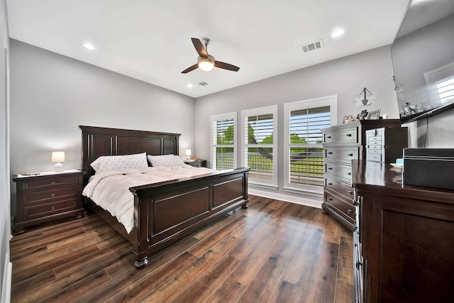 bedroom with dark hardwood / wood-style flooring and ceiling fan