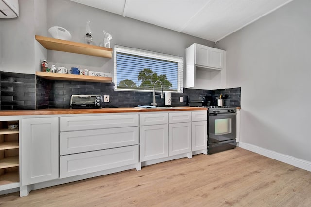 kitchen featuring wooden counters, tasteful backsplash, light wood-type flooring, and white cabinetry