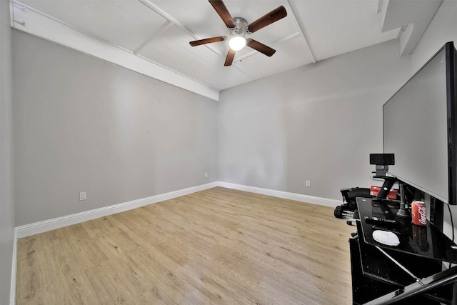 exercise room with light hardwood / wood-style flooring and ceiling fan