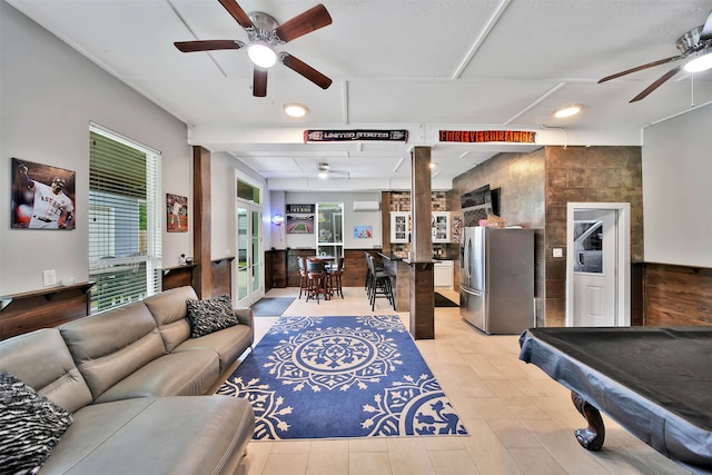 living room featuring ceiling fan, french doors, and billiards