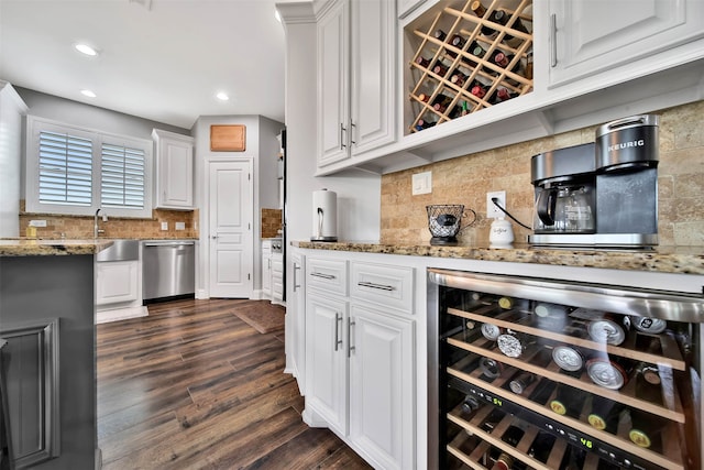 kitchen with wine cooler, white cabinets, dishwashing machine, dark wood-type flooring, and backsplash