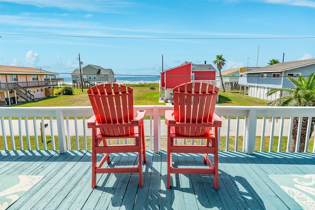 deck featuring a lawn and a water view