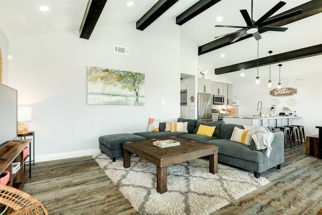 living room with ceiling fan, high vaulted ceiling, sink, light hardwood / wood-style floors, and beam ceiling