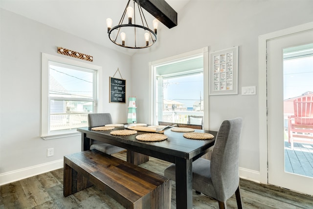 dining area featuring beamed ceiling, dark hardwood / wood-style flooring, and a chandelier