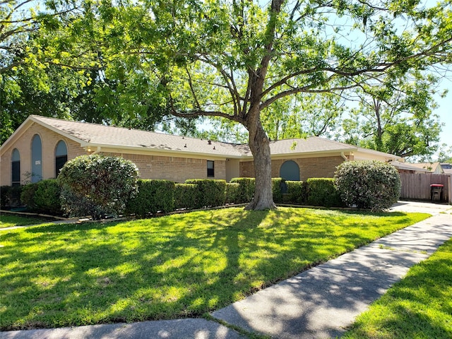 ranch-style home featuring a front lawn