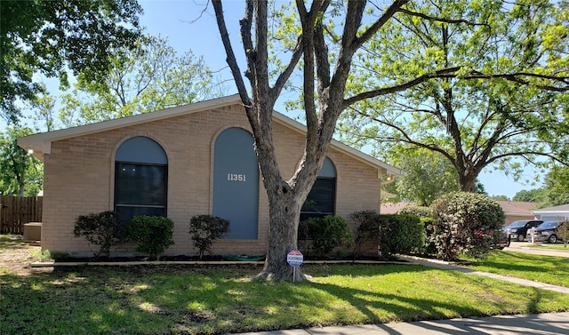 view of front facade with central AC unit and a front lawn