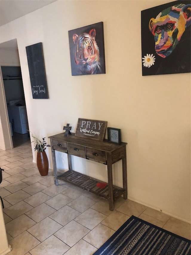 interior space with washer / clothes dryer and light tile floors