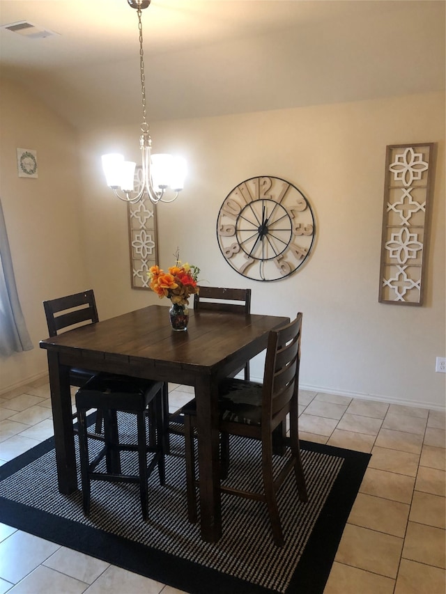 dining space featuring light tile floors and an inviting chandelier