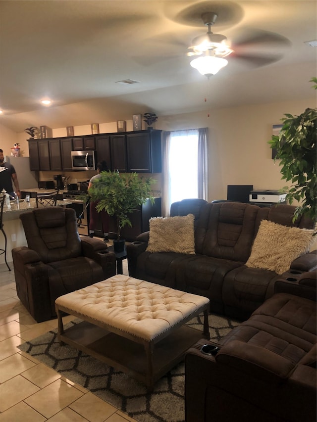 tiled living room with ceiling fan