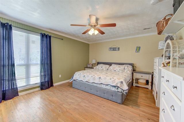 bedroom featuring ceiling fan, ornamental molding, light hardwood / wood-style floors, and multiple windows