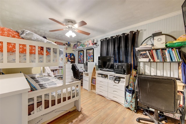 bedroom with ceiling fan, ornamental molding, and light hardwood / wood-style floors