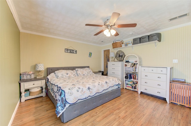 bedroom with ceiling fan, light hardwood / wood-style flooring, and ornamental molding