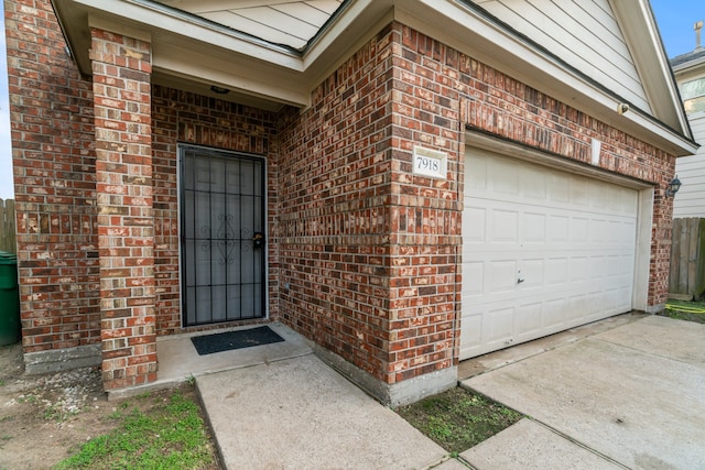 view of exterior entry with a garage