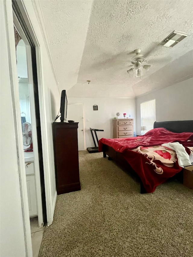 bedroom featuring ceiling fan, a textured ceiling, and light carpet