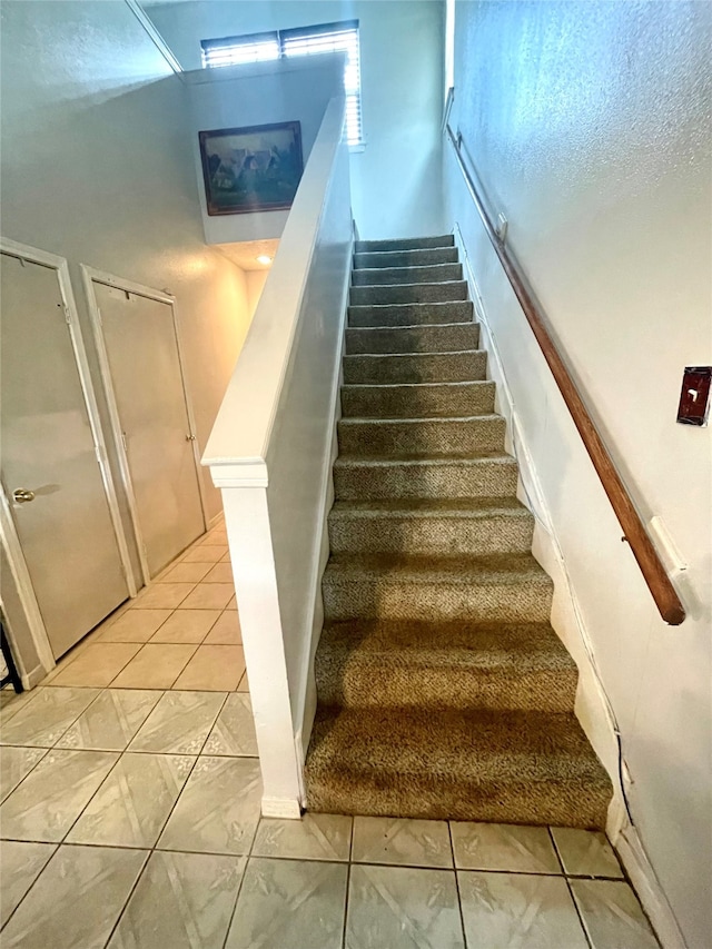 staircase with tile patterned flooring