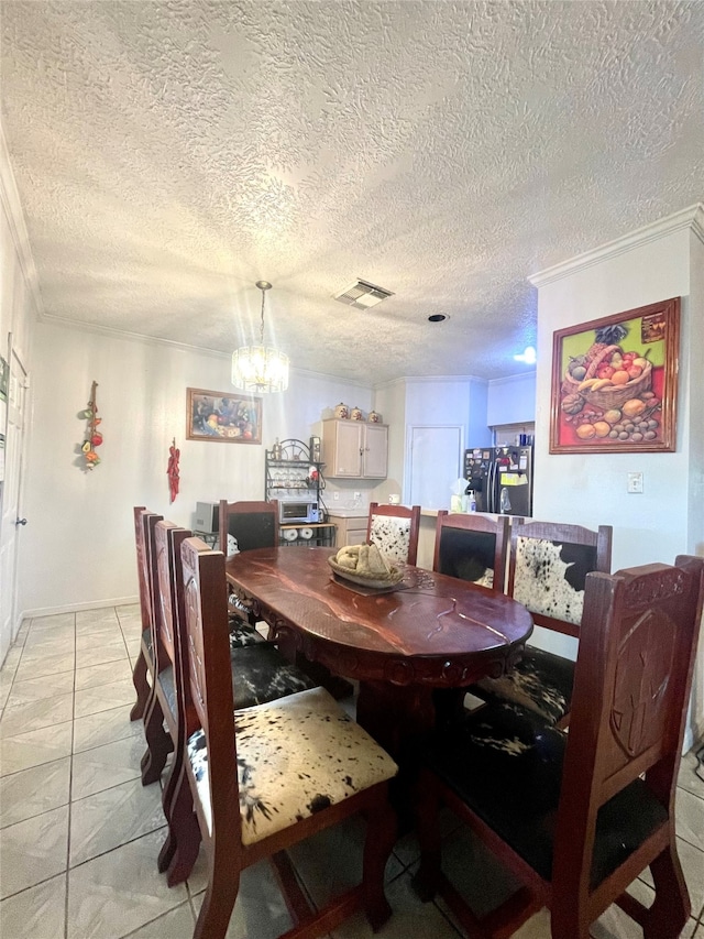 tiled dining area with a notable chandelier, a textured ceiling, and ornamental molding