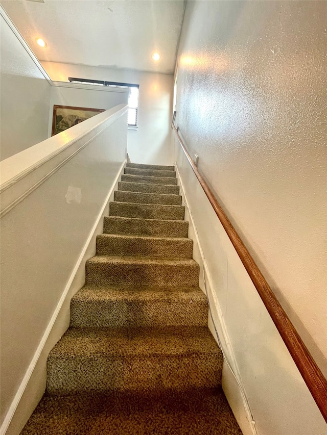 stairs featuring carpet