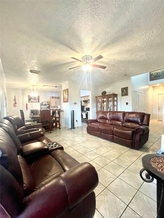 tiled living room with ceiling fan and a textured ceiling