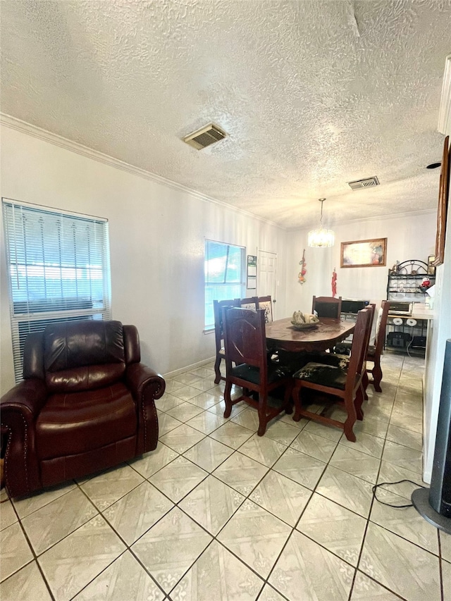 dining area featuring light tile patterned floors, a textured ceiling, a chandelier, and crown molding