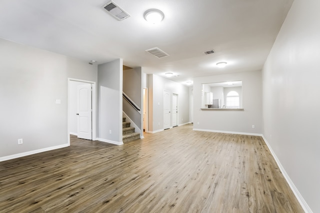 unfurnished room with hardwood / wood-style floors