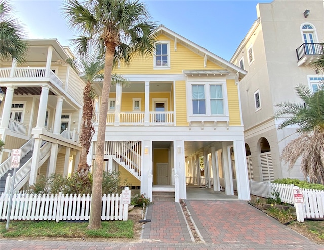 coastal inspired home with a carport and covered porch